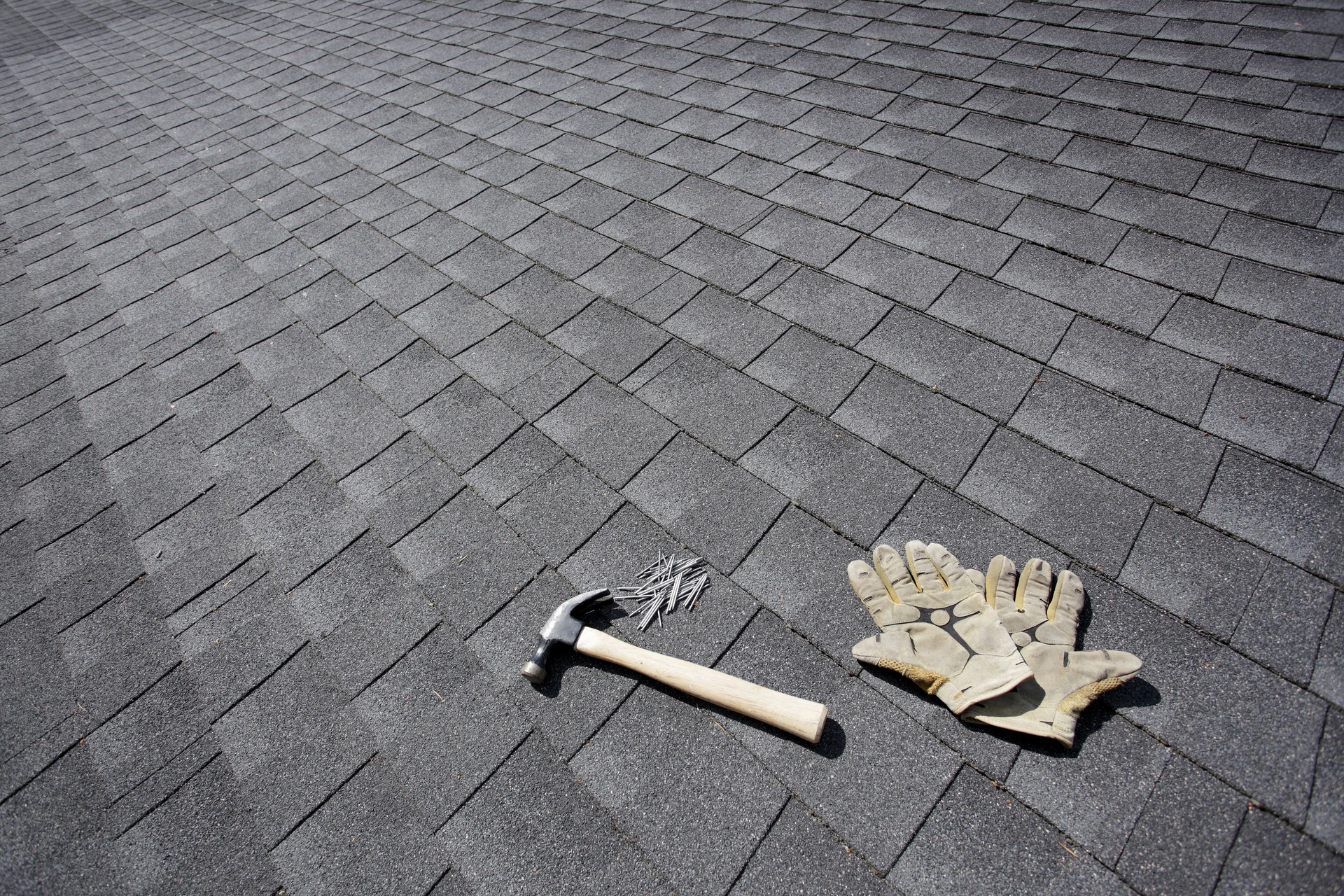 Gloves and tools on a roof during maintenance in Tampa.